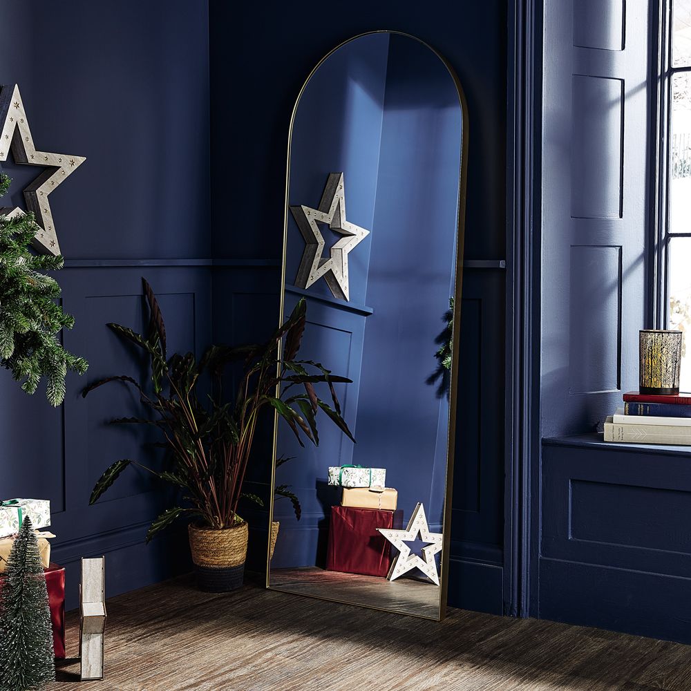 room with wooden flooring and blue wall with mirror