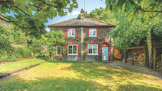 A fine brick-and-flint cottage set in landscaped gardens.