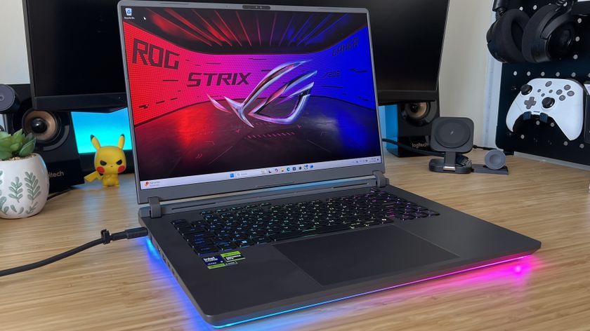Asus ROG Strix G16 gaming laptop on a wooden desk