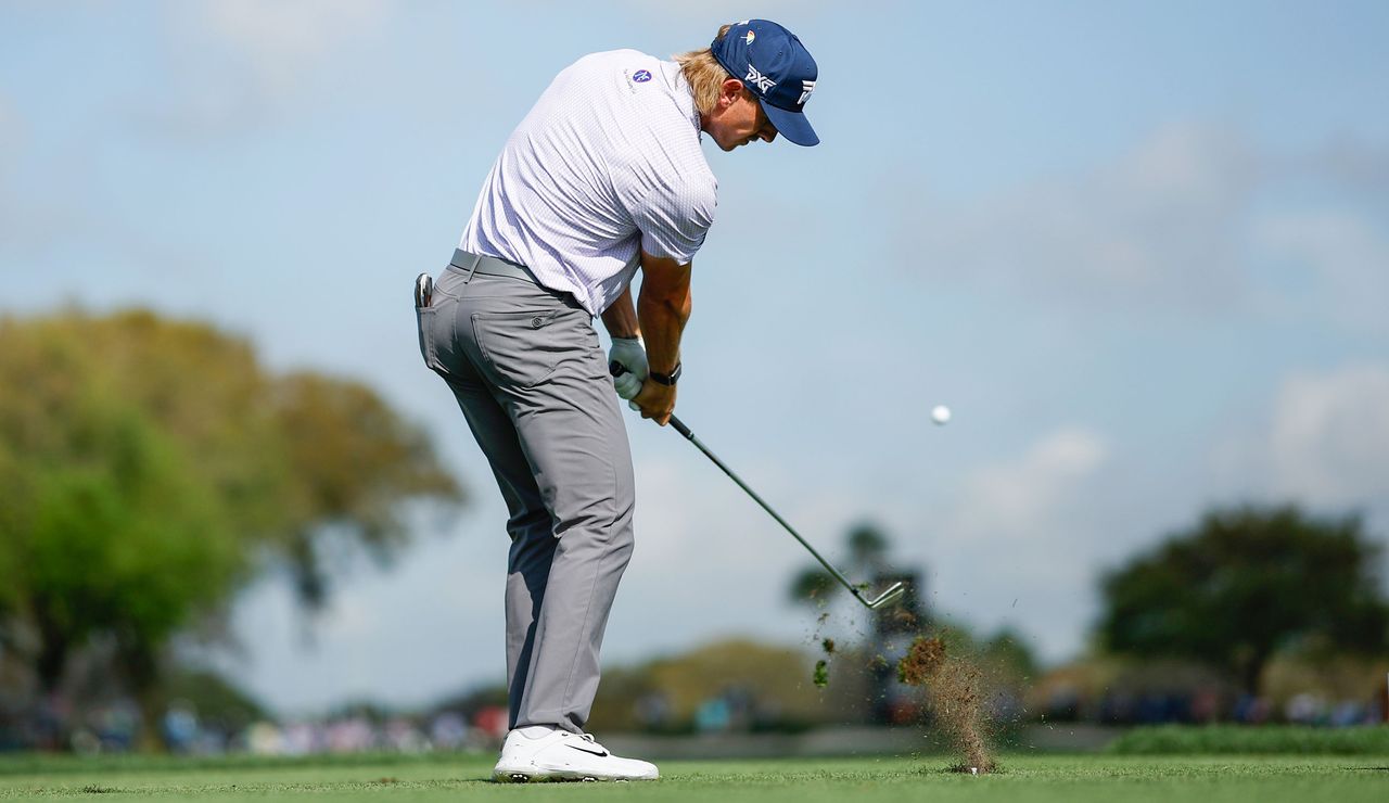 Jake Knapp strikes an iron shot from the fairway