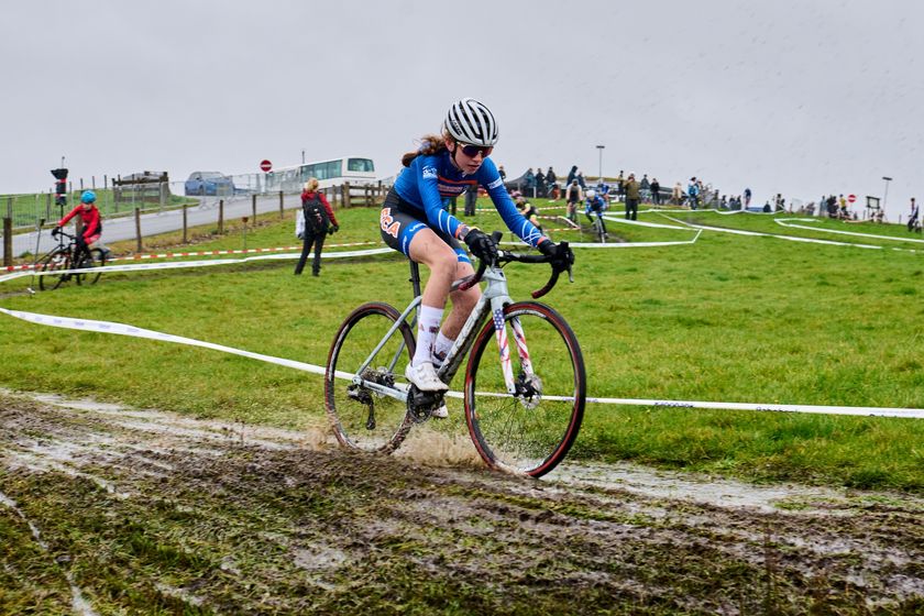 Abbygail Cole, a 15-year-old from East Granby, Connecticut, rides muddy VAM Berg course in the Netherlands on her way to victory