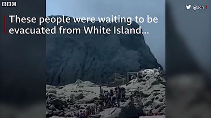 People waiting to be evacuated from White Island, New Zealand