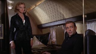 Honor Blackman looking down at Sean Connery on a plane in Goldfinger.