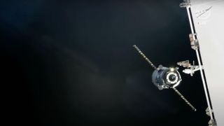 a spacecraft with solar arrays extended is seen against the blackness of space.
