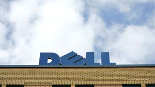 Dell sign on top of its office building with a cloudy sky in the background