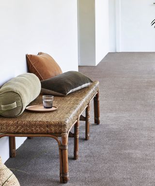 modern hallway with rattan stool, couch pillows, carpet, basket, Brintons