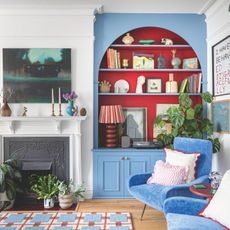 Blue built-in bookcases with red alcoves.