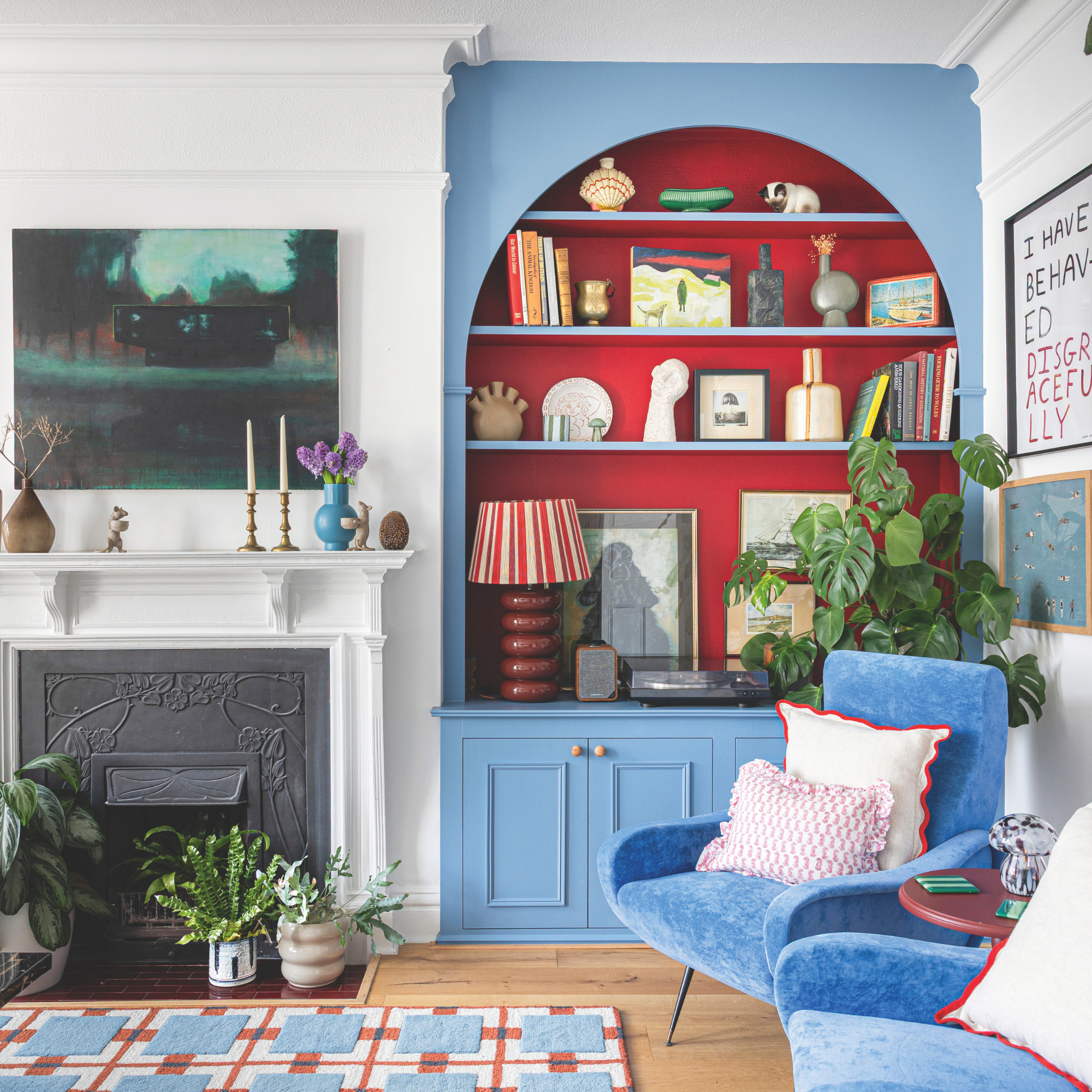 Blue built-in bookcases with red alcoves.