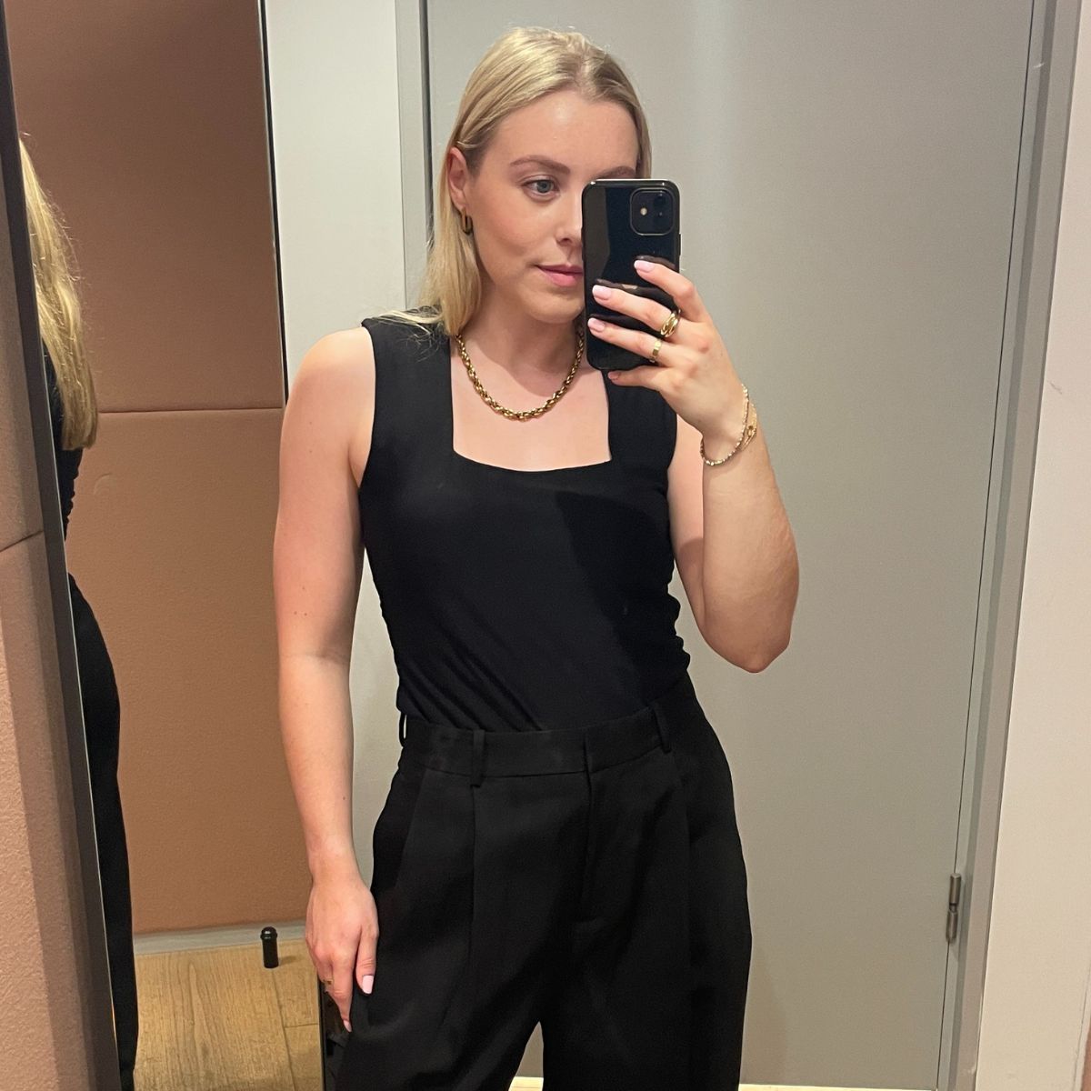 Woman wears denim trousers; woman wears black tailored trousers; woman wears barrel-leg trousers