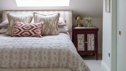 Netural bedroom styled with mid century furniture and gold lamp