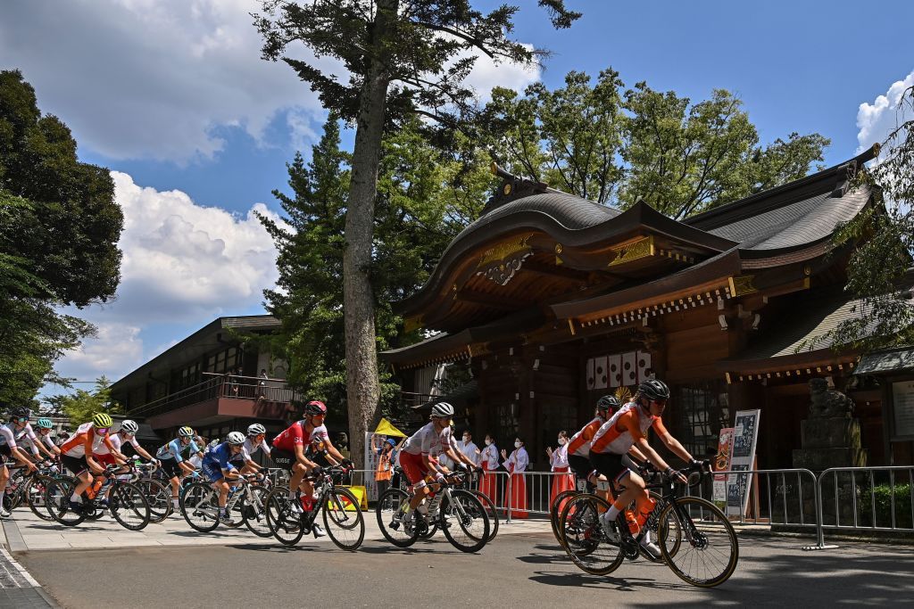 Cyclists in the peloton ride past the Okunitama shrine during the womens cycling road race of the Tokyo 2020 Olympic Games in Fuchu Japan on July 25 2021 Photo by Ben STANSALL AFP Photo by BEN STANSALLAFP via Getty Images