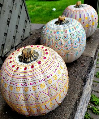 Trio of pumpkin decorating ideas with colored henna, gemstones and pearls used on ghost white pumpkins