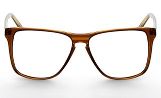 Eye wear from Han Kjobenhavn, Denmark. A rounded pair of glasses with a shiny brown frame.