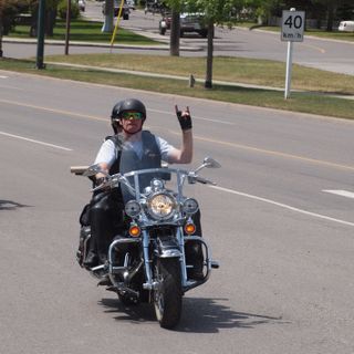 Daryl Clark of the Sons of Royalty bike ride, throwing the horns