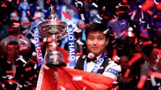 Zhao Xintong of China poses for a photo with the Halo World Snooker Championship trophy