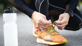 Woman tying running shoelace