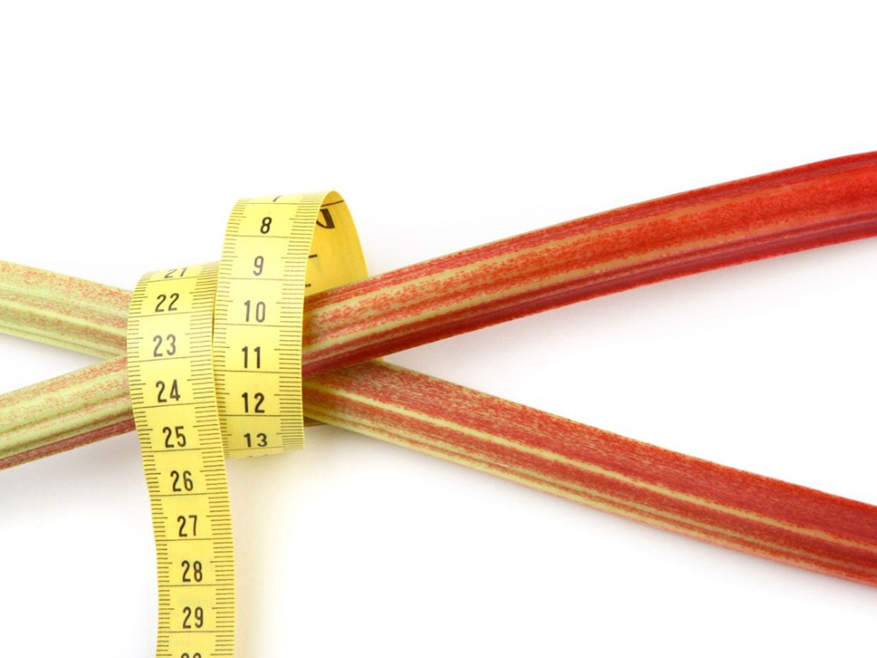 Yellow Tape Measure Wrapped Around Rhubarb Stalks