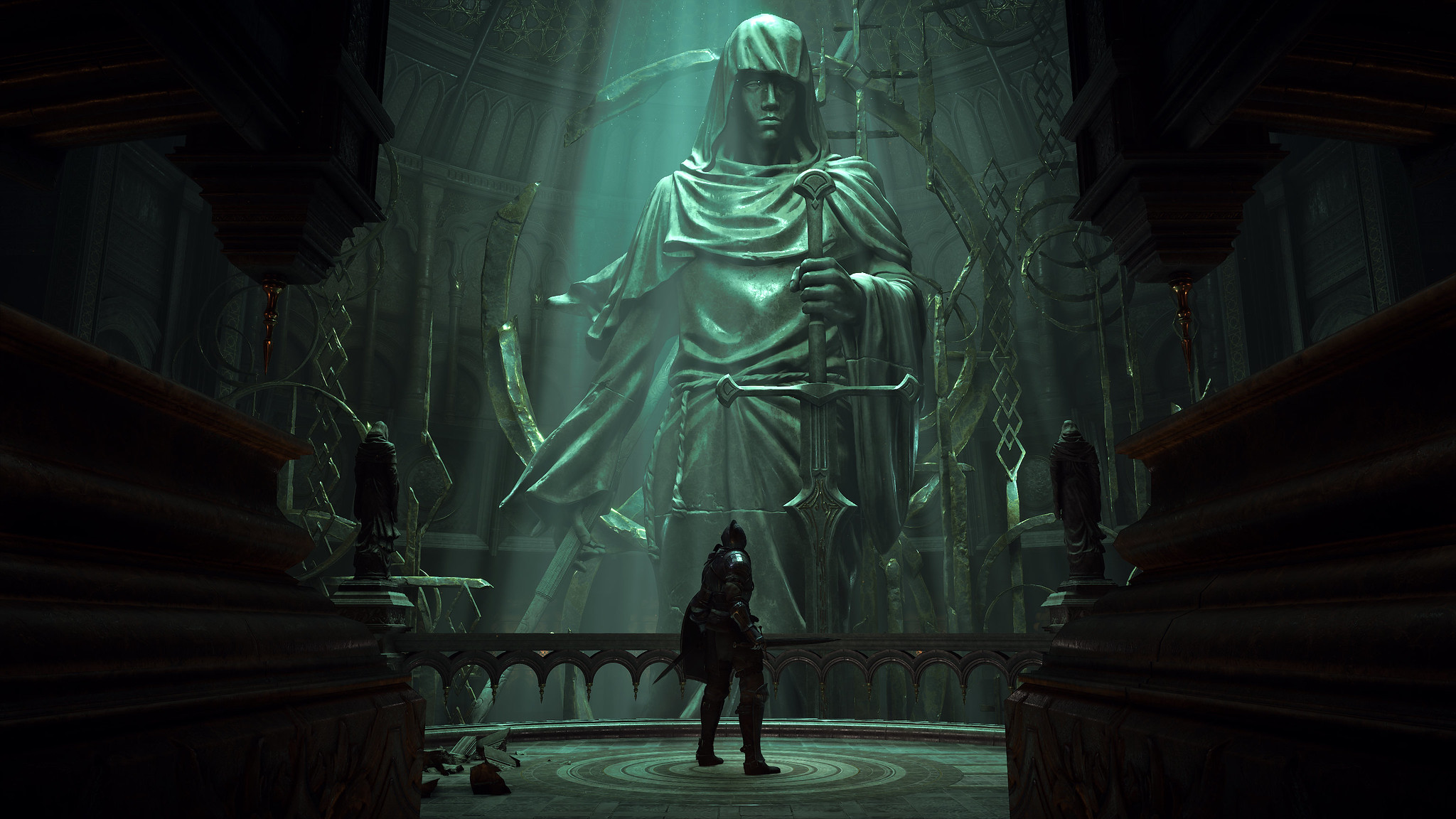 Demon's Souls - A player stands in a large chamber in front of a statue.