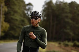 Image shows cyclist eating an energy bar