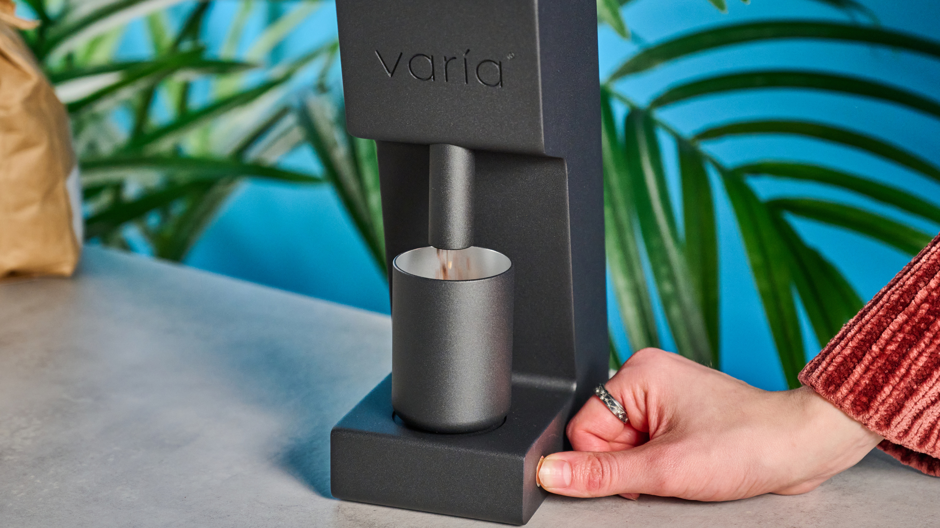 Varia vs3 penggiling kopi digunakan pada permukaan batu dengan latar belakang biru