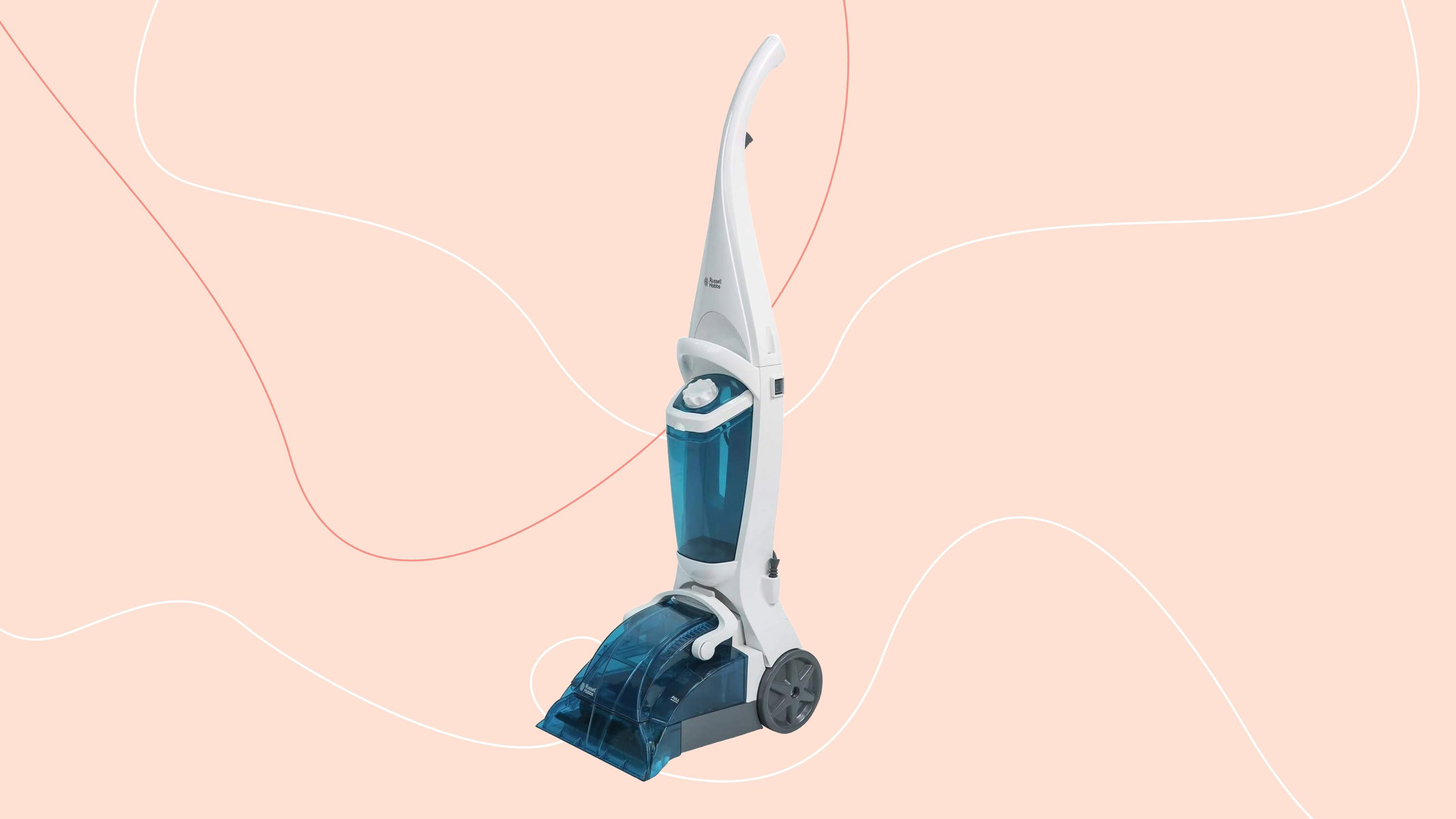 Russell Hobbs Upright Carpet Cleaner on a pink background