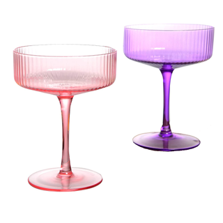 A pair of ribbed coupe glasses in pink and purple