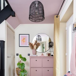 A hallway with a pink ceiling and a matching shoe cabinet