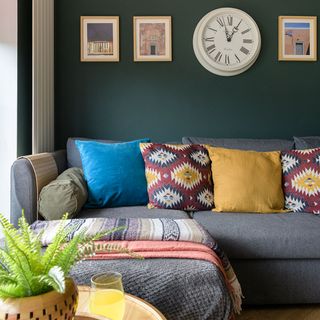 green living room with grey sofa and cushions