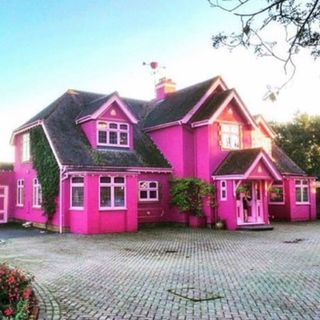house exterior with pink wall pink window and roof