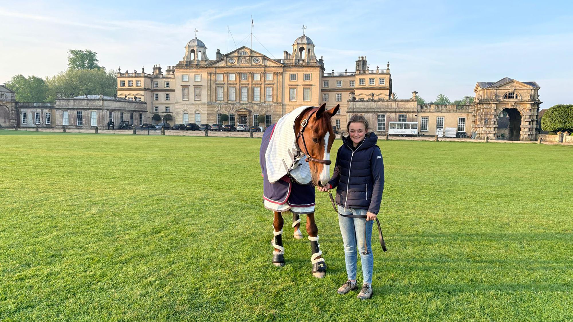 Georgie Driver, groom to Gemma Stevens, with Gemma&rsquo;s ride Chilli Knight in front of Badminton House during the 2026 event.