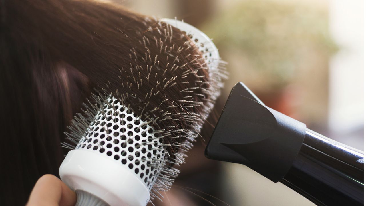 Close up of drying hair with a round brush