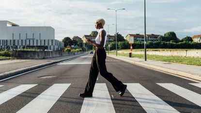 Benefits of walking: A woman crossing the road