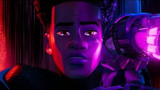 Miles Morales looks ahead defiantly with The Prowler's gauntlet next to his face in Spider-Man: Across The Spider-Verse.