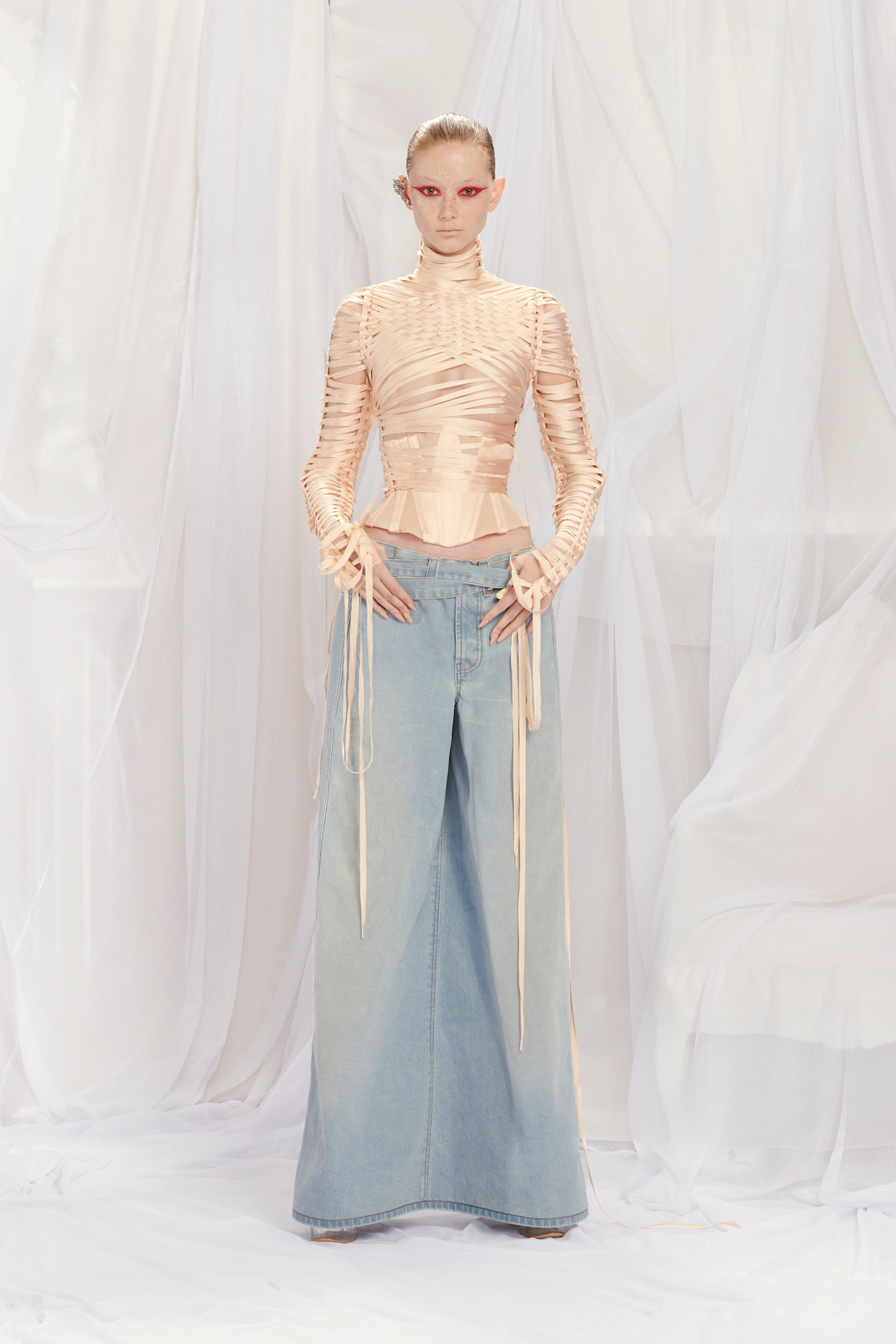 A model wore Kim Kardashian's corset with denim in the Jean Paul Gaultier Spring 2022 Couture show.