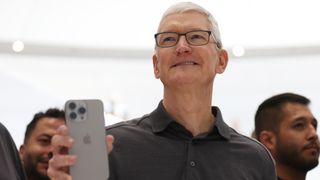 Apple CEO Tim Cook holds up a new iPhone 15 Pro during an Apple event