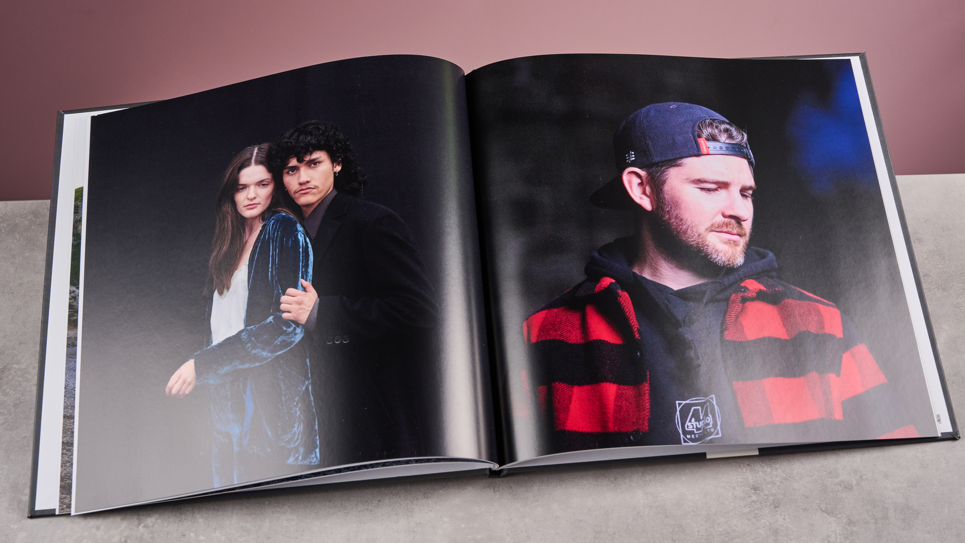 A page from the TechRadar Papier photo book, showing a couple embracing on one page and a young man in a baseball cap and flannel shirt on the other.