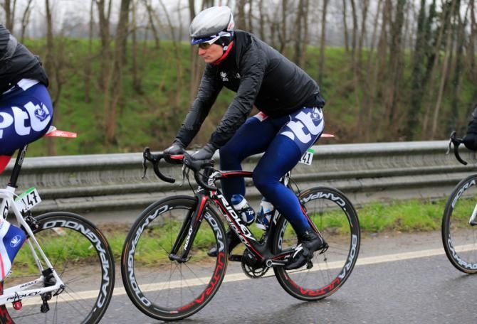 Andre Greipel (Lotto Belisol) tries to keep warm during Milan-San Remo