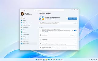 Windows Update settings showing available updates, with a download button highlighted. Light blue desktop background and taskbar visible.