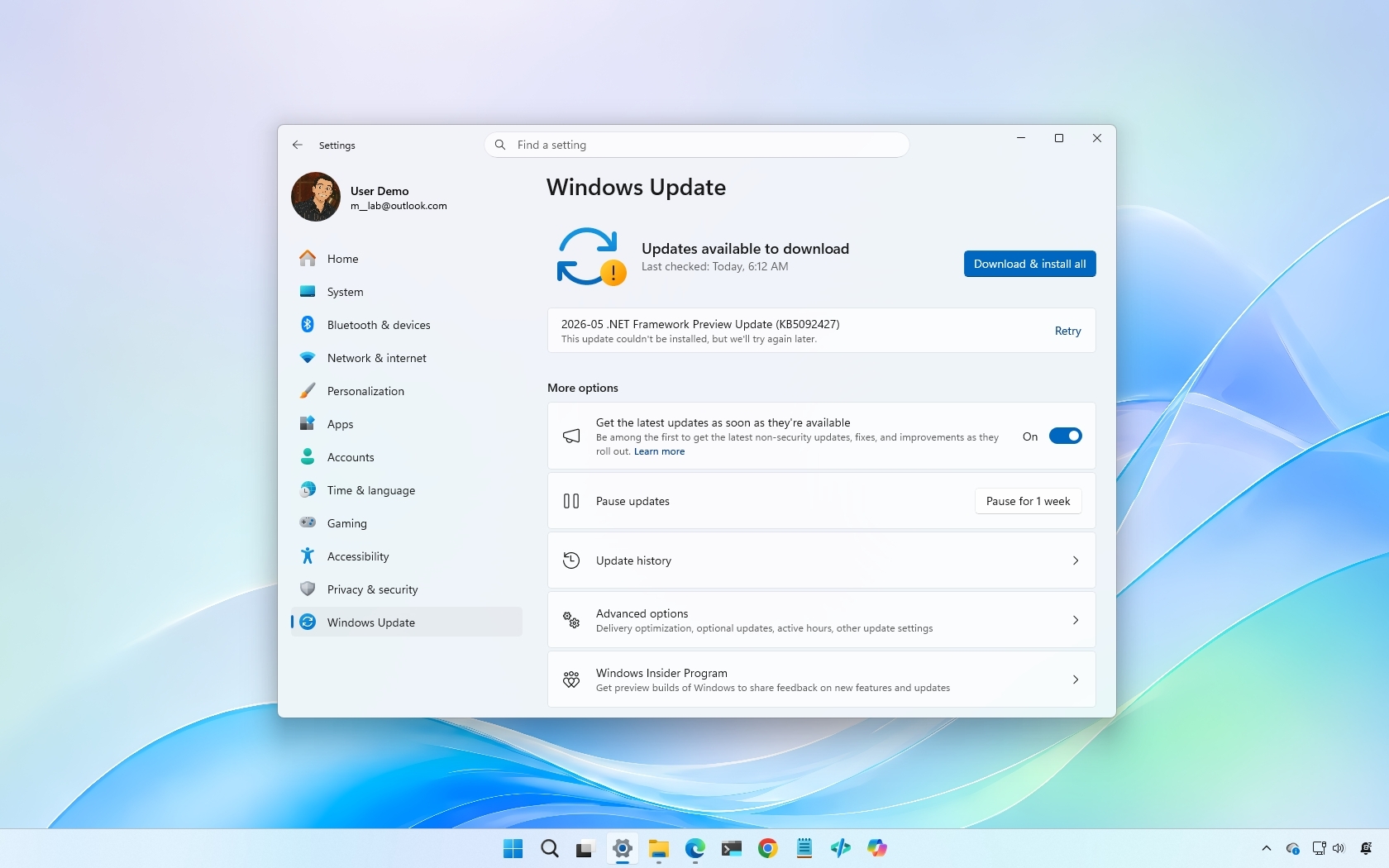 Windows Update settings showing available updates, with a download button highlighted. Light blue desktop background and taskbar visible.