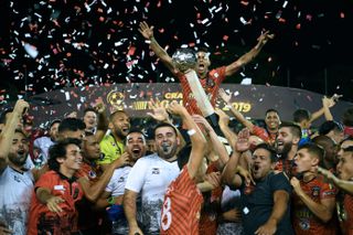 Caracas FC players celebrate with the trophy after winning the Venezuelan championship in December 2019.