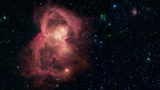 What looks like a red butterfly in space is in reality a nursery for hundreds of baby stars, revealed in this infrared image of the W40 nebula by from NASA's Spitzer Space Telescope.