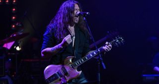 Phil X of the Drills wails into the mic as he performs with his SG-alike Gibson prototype signature guitar.