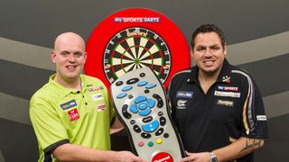 Darts superstars Michael van Gerwen and Adrian Lewis hold a giant Sky TV remote ahead of the PDC World Darts Championship 2024 Final live stream free online.