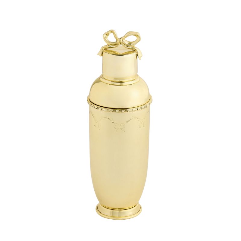 Gold cocktail shaker with bow design on lid
