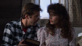 Alec Baldwin and Geena Davis looking at each other in Beetlejuice.