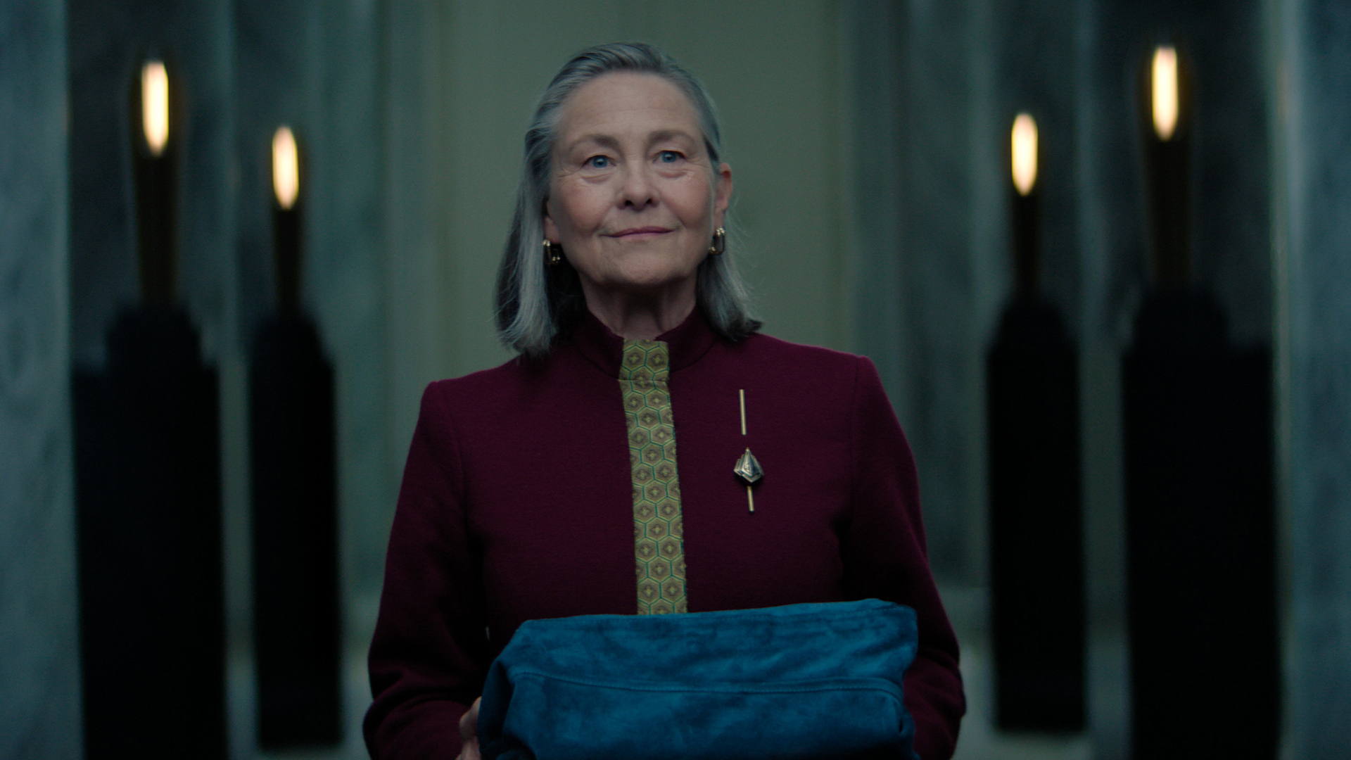 Ambassador Quent holding an object covered in cloth in Foundation season 3 episode 10