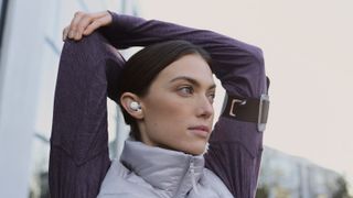 a woman wearing the sony linkbuds while working out