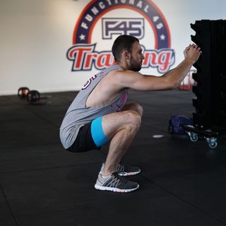 Man demonstrates midway position of the unweighted squat