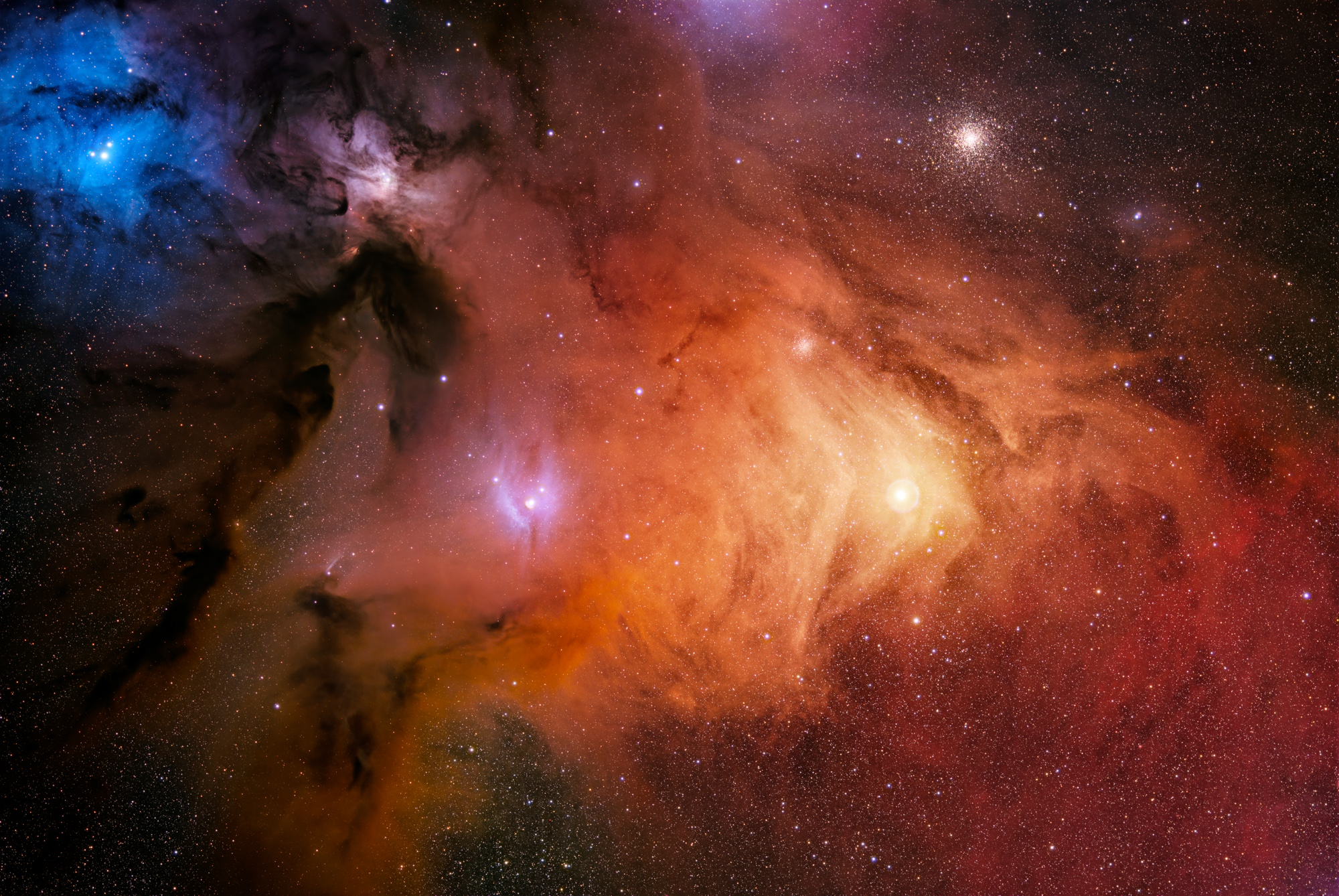 A colorful portrait of the Rho Ophiuchi stellar nursery made up of red, blue and orange interstellar clouds comprised of dust and gas. The M4 globular cluster is located at the top of the image, with the bright star Antares below.