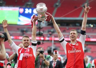 Arsenal skipper Per Mertesacker, right, and match-winner Aaron Ramsey celebrate at Wembley three years ago